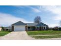 Charming single-story brick home boasts an attached garage, updated roof and meticulously kept front lawn at 511 Windward Ln, Plainfield, IN 46168