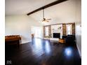 Open living room boasts hardwood floors, vaulted ceilings, and a fireplace with reclaimed wood accents at 511 Windward Ln, Plainfield, IN 46168