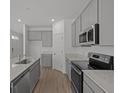 Modern kitchen with stainless steel appliances and sleek countertops at 5207 Rolling Meadow Blvd, Indianapolis, IN 46237