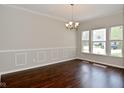 Classic dining room with a modern chandelier and natural light from large windows at 5565 Noble Dr, Indianapolis, IN 46234