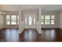 Bright foyer with dark wood floors and an oval glass front door at 5565 Noble Dr, Indianapolis, IN 46234