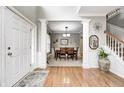 Inviting foyer with hardwood floors, decorative pillars, and a view into the formal dining room at 6124 Salisbury Ln, Noblesville, IN 46062