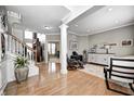 Elegant foyer featuring hardwood floors, staircase, decorative plant and views to adjacent living areas at 6124 Salisbury Ln, Noblesville, IN 46062
