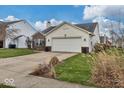 Single-Gathering home with a two-car garage and well-manicured lawn at 714 Breakers Ln, Fortville, IN 46040