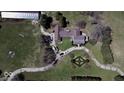 Aerial view of a home and its grounds, featuring a circular driveway at 7180 N State Road 42, Eminence, IN 46125