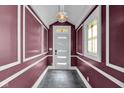 Welcoming entryway boasting stylish slate floors, an elegant light fixture, and custom trim work at 724 Lafayette Ave, Columbus, IN 47201