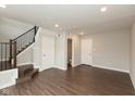 Spacious basement area with vinyl floors, a staircase, and multiple doors, offering flexible living at 7247 Barker St, Carmel, IN 46033