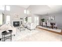 Spacious living room featuring a fireplace, large windows, and an open dining area at 797 Crossbridge Ct, Avon, IN 46123