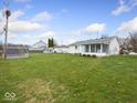 Spacious backyard featuring a screened porch and ample green space for outdoor enjoyment at 809 E Mckay Rd, Shelbyville, IN 46176