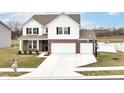 Charming home featuring a three-car garage, a basketball hoop, and a picturesque pond view in the back at 836 Grassy Branch Dr, Indianapolis, IN 46239
