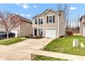Inviting two-story home showcasing a well-kept lawn, a one-car garage, and a welcoming driveway at 8808 Hosta Way, Indianapolis, IN 46113