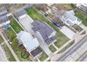An aerial view showing the house, detached garage, and gravel driveway at 902 N Anderson St, Elwood, IN 46036