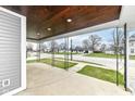 Cozy covered front porch with stained wood ceiling, offering a welcoming outdoor space at 902 N Anderson St, Elwood, IN 46036