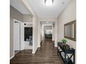 Inviting hallway with hardwood floors, leading to the living area and bedroom at 9539 Rocky Shore Dr, McCordsville, IN 46055