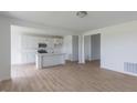 Open-concept kitchen featuring stainless appliances, a center island, and hardwood floors at 1023 Grassy Br Dr, Indianapolis, IN 46239