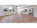 Well-lit open floor plan with a modern kitchen and plenty of natural light from large windows at 1023 Grassy Br Dr, Indianapolis, IN 46239