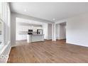 Open concept living space with a modern kitchen featuring white cabinets and a breakfast bar at 1023 Grassy Br Dr, Indianapolis, IN 46239