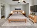 Comfortable bedroom featuring a ceiling fan, contemporary furnishings, and an ensuite bathroom for added privacy at 1066 Laura Dr, Greenwood, IN 46143