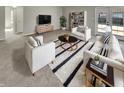 Bright living room with plush white furniture, striped accents, and a stylish oval coffee table at 1066 Laura Dr, Greenwood, IN 46143