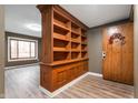 Charming living room featuring a custom bookshelf and beautiful flooring, leading to an inviting entryway at 108 Knoll Ct # A, Noblesville, IN 46062