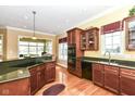Stylish kitchen showcasing dark cabinets, granite countertops, and stainless steel appliances at 10844 Fairwoods Dr, Fishers, IN 46037