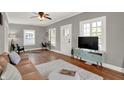 Bright living room with hardwood floors, ceiling fan, and modern décor at 112 S Spencer Ave, Indianapolis, IN 46219