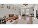 Spacious living room featuring hardwood floors, neutral paint, stylish furniture, and natural light at 112 S Spencer Ave, Indianapolis, IN 46219