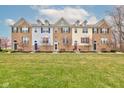 Townhomes with brick and siding, colorful doors, and manicured lawns in a quiet community at 12683 White Chapel Cir, Fishers, IN 46037