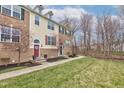 Townhomes with brick and siding, colorful doors, and landscaped lawns in a quiet community setting at 12683 White Chapel Cir, Fishers, IN 46037