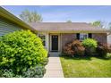 Inviting home entrance featuring brick accents, well-manicured bushes, and a paved walkway at 12741 Glengary Dr, Fishers, IN 46038