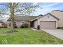Charming single story home with a well-manicured lawn and attached two car garage at 12949 Shandon Ln, Fishers, IN 46038