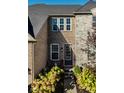 Inviting front entrance with decorative plants and brick accents enhances the home's charm at 14910 Briarpatch Cir, Carmel, IN 46033