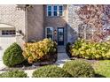 Charming front entrance with stone and brick accents and manicured landscaping welcomes visitors at 14910 Briarpatch Cir, Carmel, IN 46033