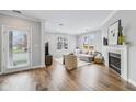 Bright living room featuring a fireplace, hardwood floors, and lots of natural light at 1557 N College Ave # 3, Indianapolis, IN 46202