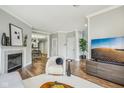 Cozy living room showcasing a fireplace, stylish decor, and hardwood flooring at 1557 N College Ave # 3, Indianapolis, IN 46202