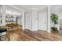 Open-concept living area featuring hardwood floors with an open view to the dining and kitchen area at 1557 N College Ave # 3, Indianapolis, IN 46202