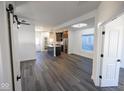 Bright open-concept living area with gray wood floors, white walls, and a modern kitchen at 1711 Ringgold Ave, Indianapolis, IN 46203
