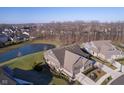 Overhead shot of a beautifully landscaped home with a serene pond in a peaceful neighborhood setting at 17346 Haxby Ln, Westfield, IN 46074