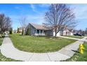 Suburban home with a green lawn, a sidewalk, and a well-maintained yard under a blue sky at 18875 Pilot Mills Dr, Noblesville, IN 46062