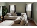 Bright living room features a large sectional sofa, hardwood floors, and natural light from windows at 212 Walnut St, Greenfield, IN 46140