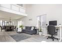 Bright living room featuring vaulted ceilings, modern decor, and an adjacent dining area at 2421 Grand Fir Dr, Greenwood, IN 46143