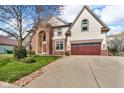 Two-story home featuring a brick exterior, well-manicured lawn, and attached garage at 250 W Tansey Crossing, Westfield, IN 46074