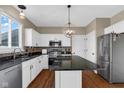 Modern kitchen features granite countertops, stainless appliances, island, and a stylish pendant light at 250 W Tansey Crossing, Westfield, IN 46074