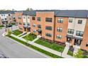 Brick townhomes featuring modern architecture, landscaped lawns, and street parking at 2578 Filson St, Carmel, IN 46032