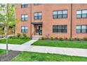 Brick townhome with a covered entry, landscaped lawn, and a concrete walkway at 2578 Filson St, Carmel, IN 46032