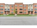 Modern brick townhomes featuring well-manicured lawns, a walkway, and large windows at 2578 Filson St, Carmel, IN 46032