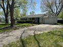Traditional home with an attached garage and a neat, well-maintained front yard and landscaping at 2843 Canterbury Ln, Indianapolis, IN 46220