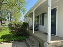 Inviting front porch with seating, arched trim, and a charming entrance to the home at 2843 Canterbury Ln, Indianapolis, IN 46220