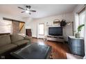 Inviting living room featuring hardwood floors, a ceiling fan, and a sliding barn door at 2909 Huntsville Rd, Pendleton, IN 46064
