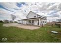 Beautiful two-story home with a covered porch, gravel driveway, and large grassy yard at 2968 W Old Franklin Rd, Shelbyville, IN 46176